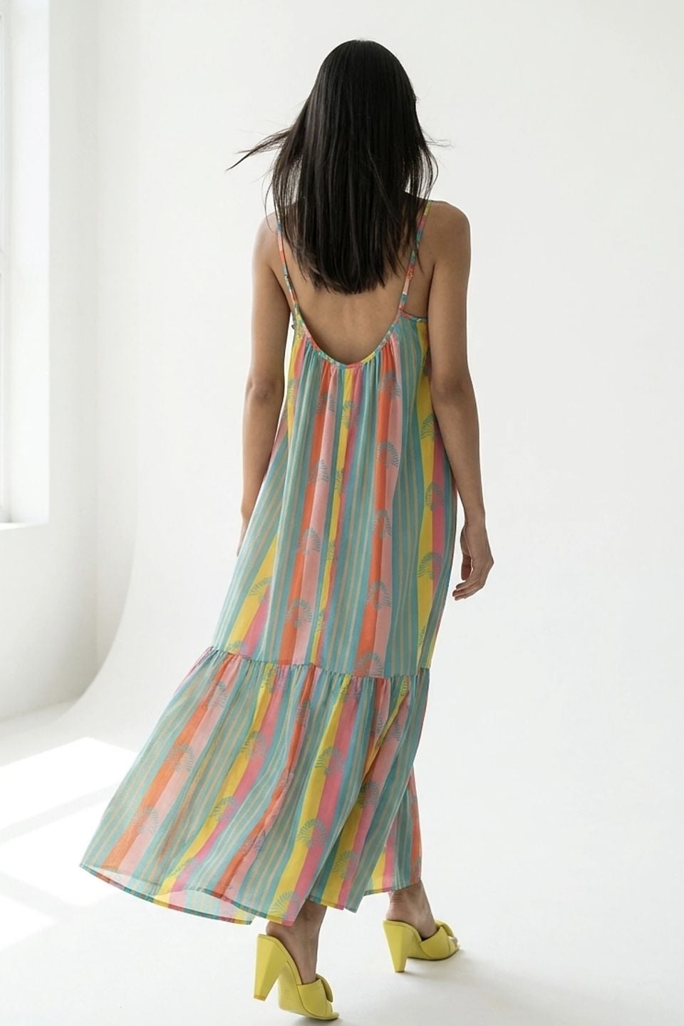 Vibrant striped maxi dress with fan motif and ruffle hem