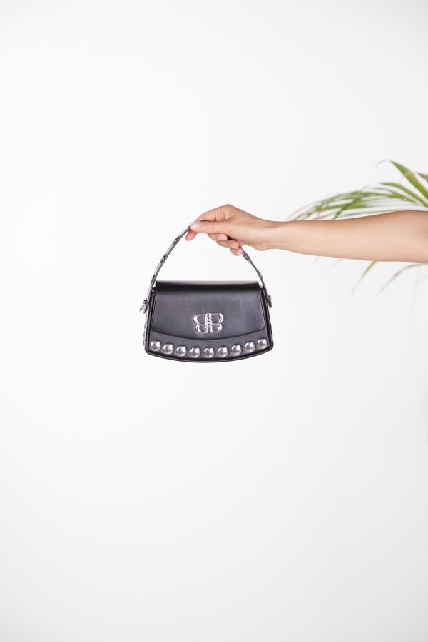 Handbag with metal studs and monogram