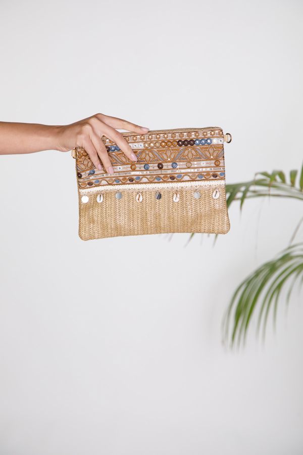 Woven clutch bag with embroidery and seashell charms