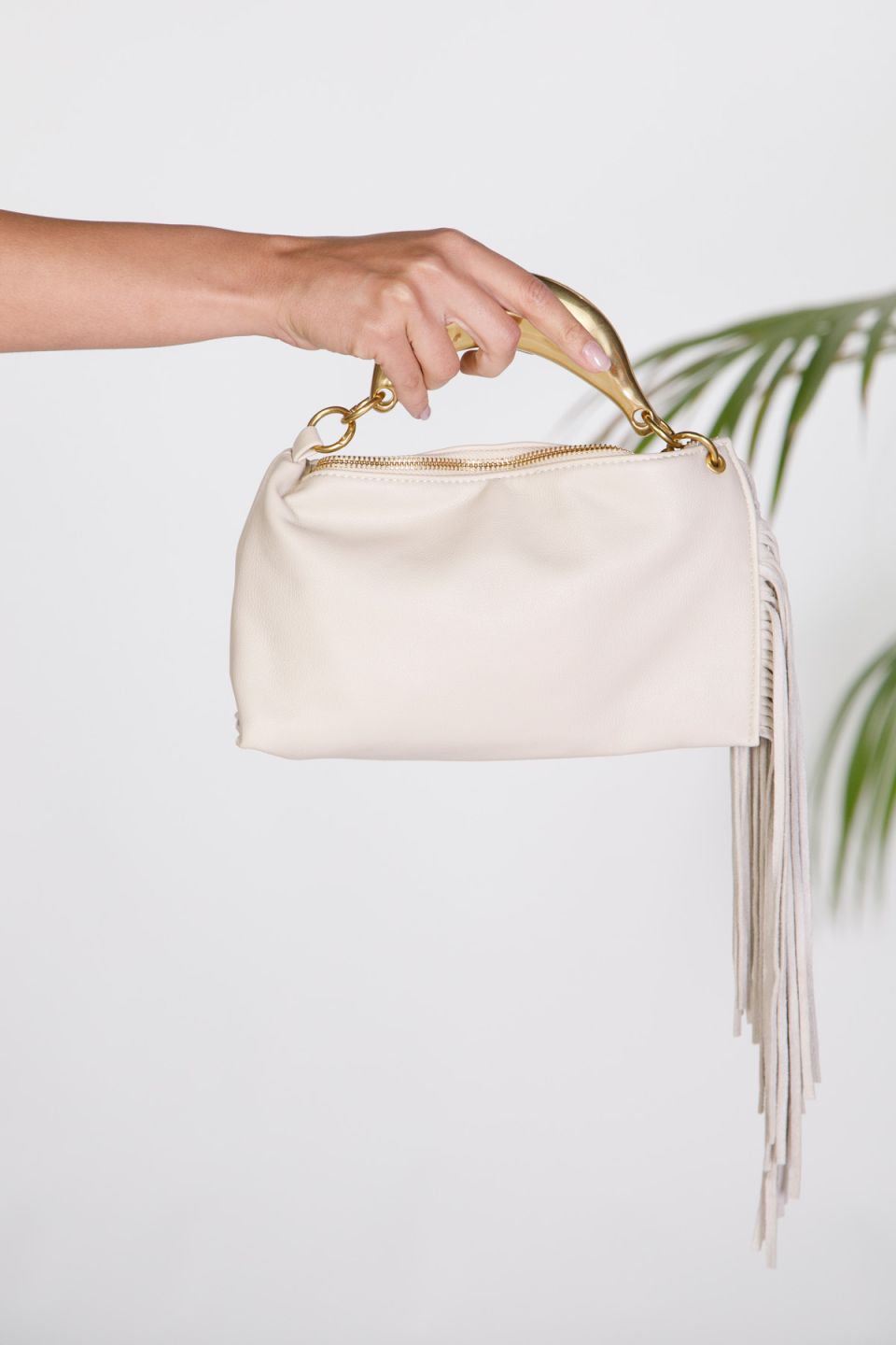 Handbag with metallic top handle and long fringe