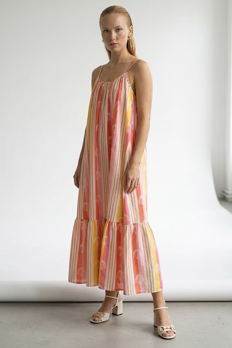 Vibrant striped maxi dress with fan motif and ruffle hem